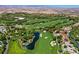 Picturesque aerial view of a golf course community, showcasing lush greenery, water features, and luxury homes at 10 Olympia Outlook Dr, Las Vegas, NV 89141