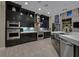 Modern kitchen with stainless steel appliances, hardwood floors, and sleek cabinetry at 10 Olympia Outlook Dr, Las Vegas, NV 89141