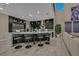 Spacious kitchen featuring a center island with barstool seating, hardwood floors, and an open living area at 10 Olympia Outlook Dr, Las Vegas, NV 89141