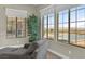 Bright living area with floor-to-ceiling windows showcasing views of the pool and city skyline at 10 Olympia Outlook Dr, Las Vegas, NV 89141