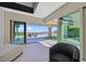 Bright living room with expansive sliding glass doors, seamless indoor/outdoor living and desert views at 10 Olympia Outlook Dr, Las Vegas, NV 89141