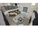 Open-concept living room with a view of the game room and modern staircase at 10 Olympia Outlook Dr, Las Vegas, NV 89141