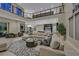 Bright open living room with a large sectional sofa and views into the dining room at 10 Olympia Outlook Dr, Las Vegas, NV 89141