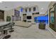 Open-concept living room featuring a fireplace, high ceilings and an adjacent modern kitchen at 10 Olympia Outlook Dr, Las Vegas, NV 89141