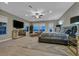 Luxurious main bedroom featuring large windows, plush seating, and a mirrored dresser at 10 Olympia Outlook Dr, Las Vegas, NV 89141