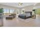 Spacious main bedroom offering a sitting area, light wood floors, and an outdoor view at 10 Olympia Outlook Dr, Las Vegas, NV 89141