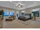 Spacious main bedroom featuring neutral tones, large windows, and comfortable seating area at 10 Olympia Outlook Dr, Las Vegas, NV 89141