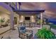 Outdoor living area with kitchen, bar seating, lounge area, and beautiful city views at 10 Olympia Outlook Dr, Las Vegas, NV 89141