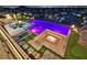 Aerial view of a backyard featuring a uniquely shaped pool with a built-in fire pit and seating area, perfect for entertaining at 10 Olympia Outlook Dr, Las Vegas, NV 89141