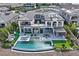 Aerial view of a luxury home featuring a beautiful backyard with pool, spa, and covered outdoor living space at 10 Olympia Outlook Dr, Las Vegas, NV 89141