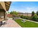 Lush backyard featuring a well-maintained lawn, a charming stone statue, and patio with outdoor seating at 10305 Turia Gardens Rd, Las Vegas, NV 89135