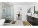 Bright bathroom featuring a glass shower, soaking tub, double vanity and vessel sinks at 10305 Turia Gardens Rd, Las Vegas, NV 89135