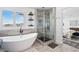 Luxurious bathroom featuring soaking tub, glass-enclosed shower, and modern finishes at 10305 Turia Gardens Rd, Las Vegas, NV 89135