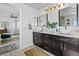 Bright bathroom with double vanity featuring white quartz countertops and modern vessel sinks at 10305 Turia Gardens Rd, Las Vegas, NV 89135