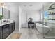 Bright bathroom with vessel sink vanity, soaking tub, and glass shower at 10305 Turia Gardens Rd, Las Vegas, NV 89135