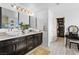 Bright bathroom with double vanity, vessel sinks, quartz countertops, and a walk-in closet at 10305 Turia Gardens Rd, Las Vegas, NV 89135