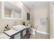 Neutral-toned bathroom featuring modern vanity, white sink, updated toilet and stylish decor at 10305 Turia Gardens Rd, Las Vegas, NV 89135