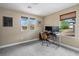 Office bedroom with three windows overlooking a lovely view and a stylish, ergonomic desk at 10305 Turia Gardens Rd, Las Vegas, NV 89135