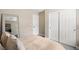 Neutral bedroom featuring sliding closet, door, full length mirror and coordinated decor and a comfortable bed at 10305 Turia Gardens Rd, Las Vegas, NV 89135