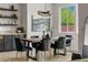 Modern dining room with stylish chandelier, seating for six, and built-in hutch with granite countertops at 10305 Turia Gardens Rd, Las Vegas, NV 89135