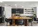 Modern kitchen with stainless steel appliances, a center island with bar seating, and open shelving at 10305 Turia Gardens Rd, Las Vegas, NV 89135