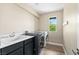 Laundry room with a washer and dryer hookup, utility sink, and natural light at 10305 Turia Gardens Rd, Las Vegas, NV 89135