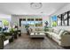 Spacious living room with large windows, comfortable seating, and stylish decor at 10305 Turia Gardens Rd, Las Vegas, NV 89135