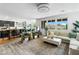 Open concept living room with large windows, modern furnishings, and views of the kitchen at 10305 Turia Gardens Rd, Las Vegas, NV 89135
