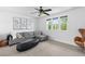 Bright sitting area with modern decor, comfortable sofa, and three large windows offering natural light at 10305 Turia Gardens Rd, Las Vegas, NV 89135