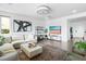 Open-concept living area with a comfortable sectional sofa and modern decor at 10305 Turia Gardens Rd, Las Vegas, NV 89135