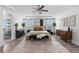 Spacious main bedroom boasts tray ceilings, ceiling fan, and access to luxurious ensuite bathroom at 10305 Turia Gardens Rd, Las Vegas, NV 89135