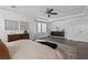 Comfortable main bedroom with tray ceilings, ceiling fan, a dresser, and natural light at 10305 Turia Gardens Rd, Las Vegas, NV 89135