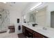 Bright bathroom with double sinks, a soaking tub, and a separate shower with marble surround at 10325 Falls Church Ave, Las Vegas, NV 89144