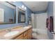 Bathroom featuring double sinks, matching framed mirrors, shower and tub with blue accent wall at 10325 Falls Church Ave, Las Vegas, NV 89144