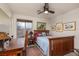 Comfortable bedroom with desk, window, ceiling fan, and attractive furnishings and decor at 10325 Falls Church Ave, Las Vegas, NV 89144