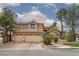 Charming two-story home featuring a three-car garage, desert landscaping, and a beautiful red tile roof at 10325 Falls Church Ave, Las Vegas, NV 89144