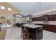 Open kitchen with granite countertops, stainless steel appliances, tile floors, and adjacent dining area at 10325 Falls Church Ave, Las Vegas, NV 89144