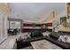 Open floor plan with a spacious living room featuring a large leather sofa and access to the kitchen and dining area at 10325 Falls Church Ave, Las Vegas, NV 89144