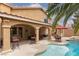 A backyard pool and covered patio area, perfect for relaxation and outdoor entertaining at 10325 Falls Church Ave, Las Vegas, NV 89144