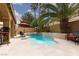 Inviting backyard pool with surrounding patio space, mature landscaping, and shade at 10325 Falls Church Ave, Las Vegas, NV 89144
