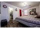 Cozy bedroom featuring wood-look flooring, a decorative dresser, and a walk-in closet at 1035 Spotted Saddle St, Henderson, NV 89015