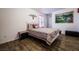Charming bedroom with wood-look flooring and a large picture on the wall at 1035 Spotted Saddle St, Henderson, NV 89015