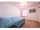 Bedroom with plush carpet, ceiling fan, and a large window with natural light at 1035 Spotted Saddle St, Henderson, NV 89015
