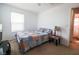 Bedroom with neutral carpet, ceiling fan, and a view of the bathroom at 1035 Spotted Saddle St, Henderson, NV 89015