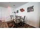 Cozy dining area with table and four chairs, adjacent to the staircase and decorated with art and Gathering photos at 1035 Spotted Saddle St, Henderson, NV 89015