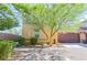 Charming two-story home with a two-car garage, landscaped front yard with lush green trees, and a brick driveway at 1035 Spotted Saddle St, Henderson, NV 89015