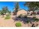 Inviting front yard with mature trees, drought-resistant landscaping, and a cozy bench at 1035 Spotted Saddle St, Henderson, NV 89015