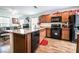 Updated kitchen with granite countertops, black appliances, and a spacious center island with dark wood cabinets at 1035 Spotted Saddle St, Henderson, NV 89015