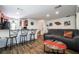 Inviting living area with wood flooring, gray sofas, modern decor, and a view of the adjacent dining and kitchen at 1035 Spotted Saddle St, Henderson, NV 89015