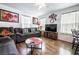 Inviting living room with comfortable gray sofa, modern decor, and wood-style flooring, perfect for relaxation at 1035 Spotted Saddle St, Henderson, NV 89015